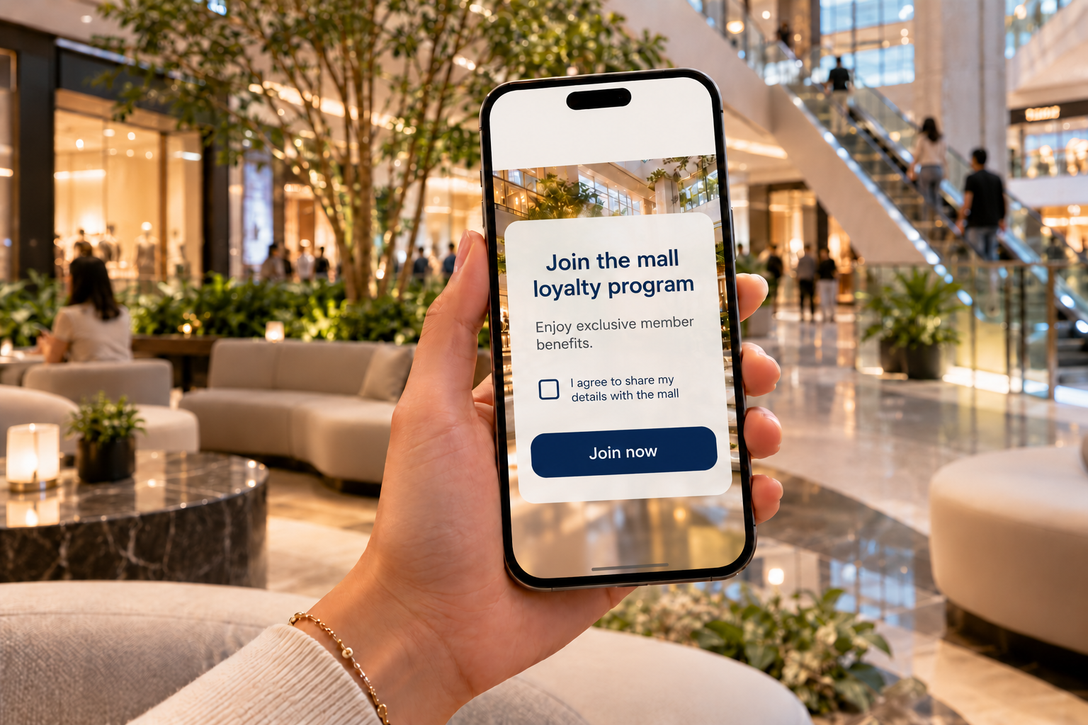 A single mall loyalty program enrollment screen on a phone in a shopping mall lounge